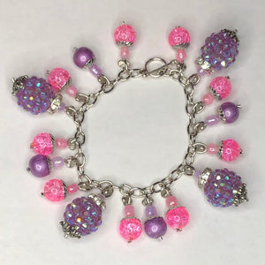 Silver child's bracelet with pick and purple accents